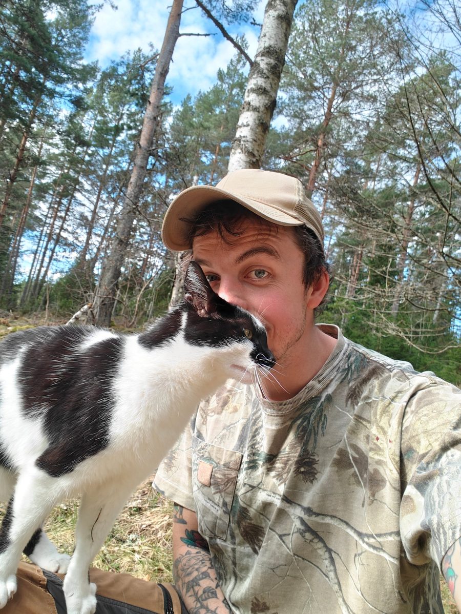 JoJo in the forest with his black-and-white cat